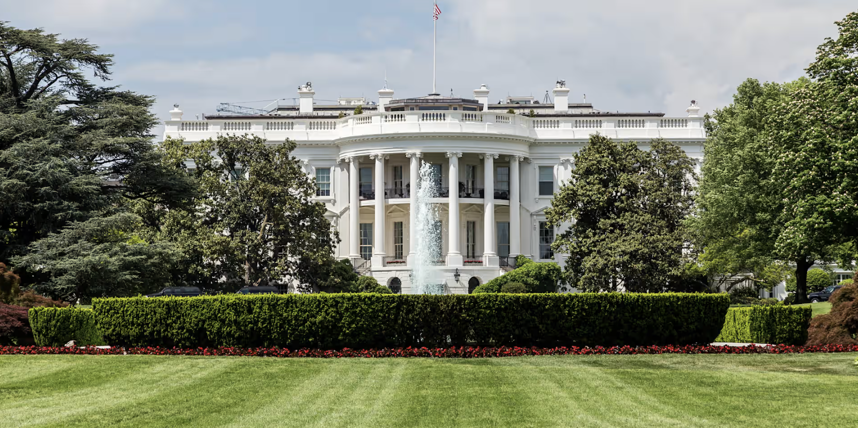 The South Lawn of the White House with the American flag flying above the portico
